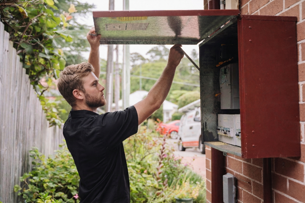 Electrician installing downlights in a Northbridge home